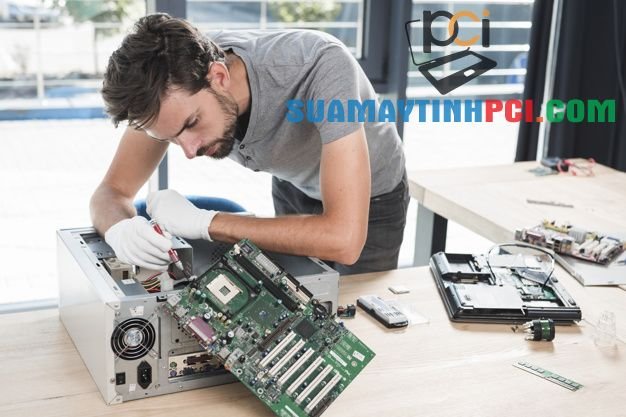 Premium Photo | Male technician repairing computer in workshop